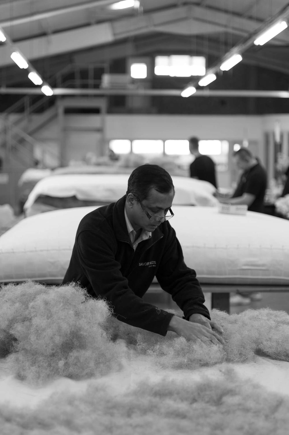Savoir Beds craftsmen making one of the custom size beds