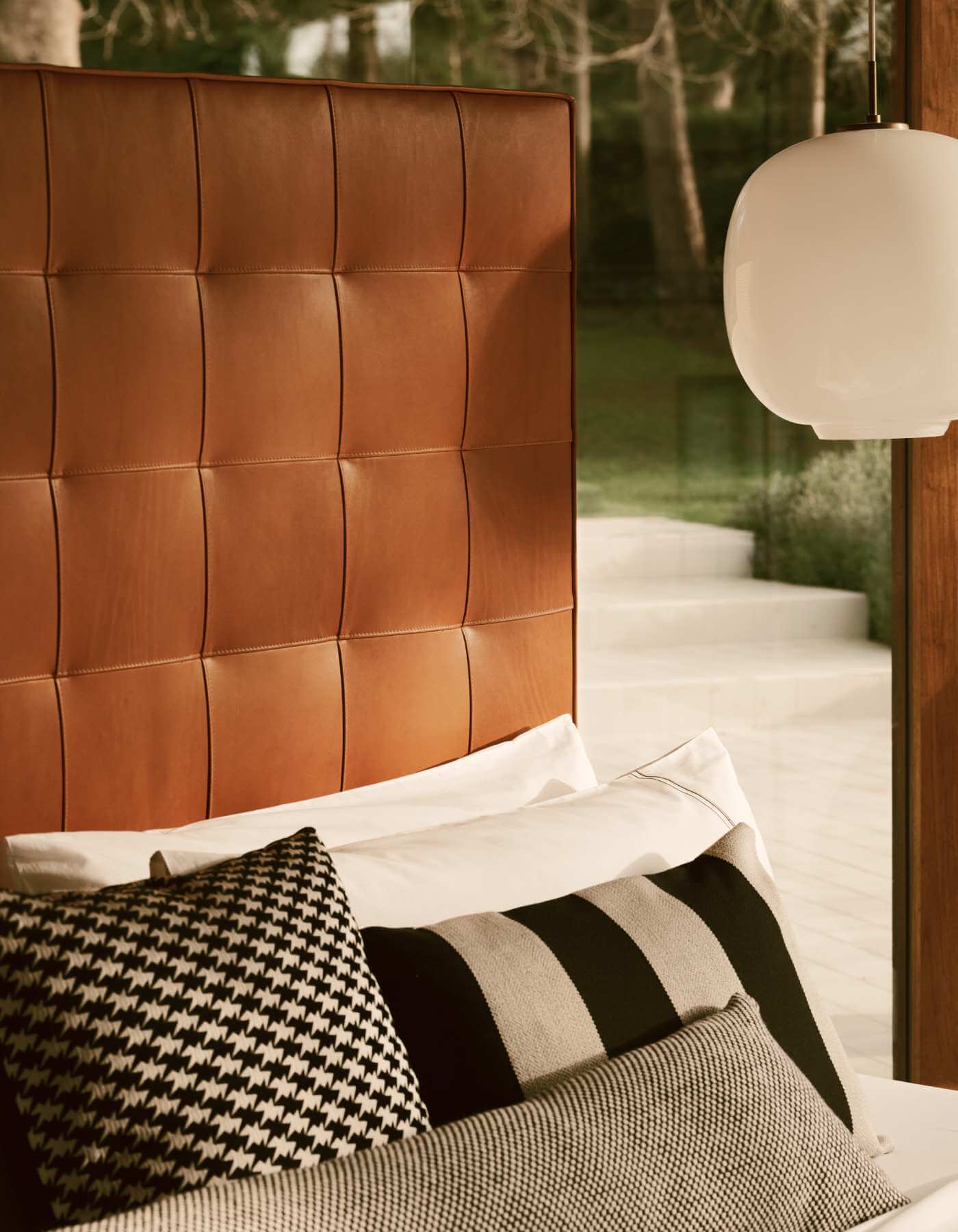 A close-up of the rectangular Winston headboard upholstered in textural organic cognac leather