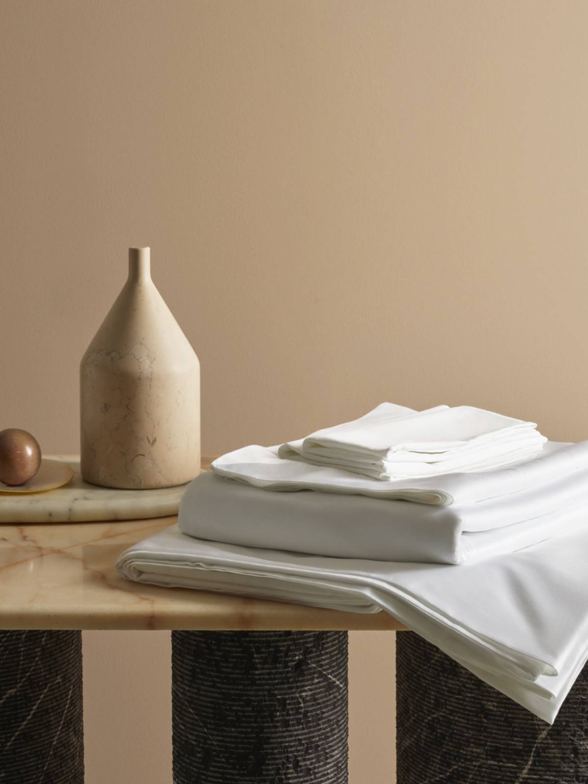 Savoir bed linen beautifully arranged on a marble table