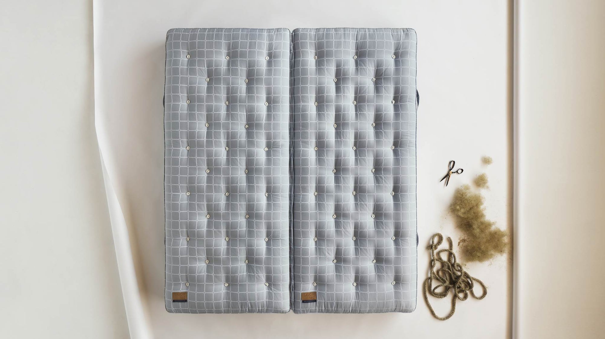 Savoir mattress laid on the floor with natural material next to it
