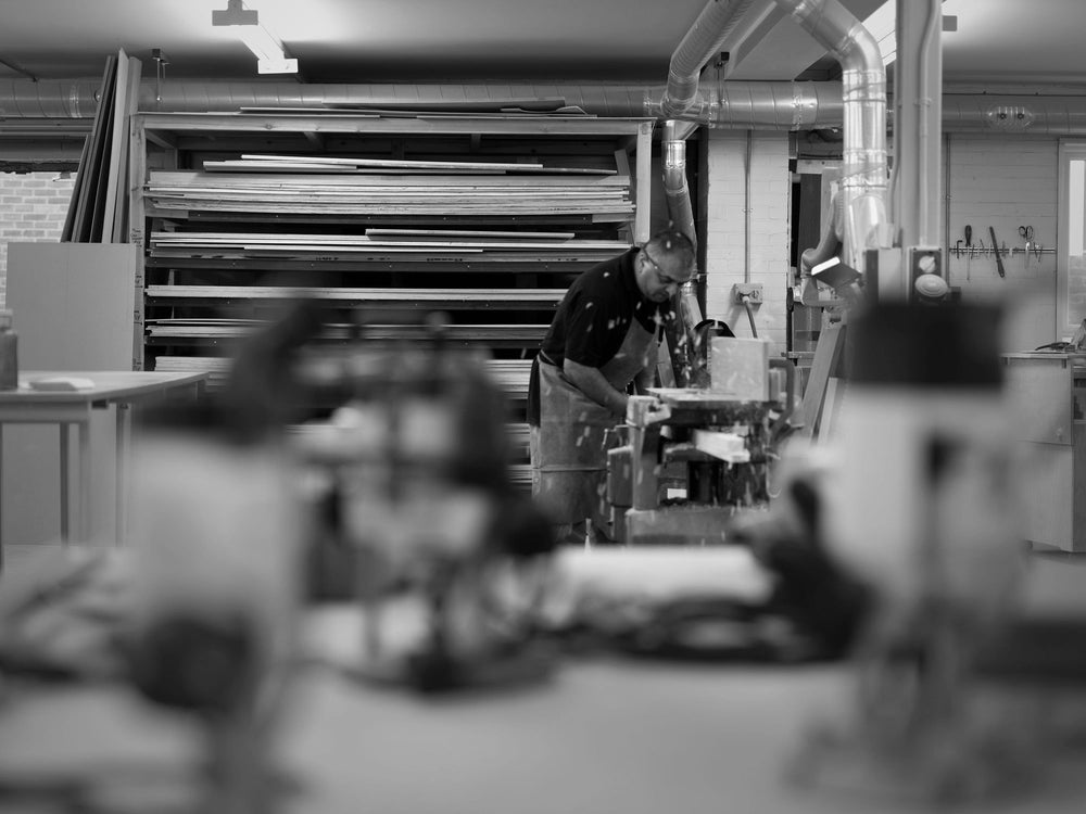 A Savoir craftsman working on some wood panels