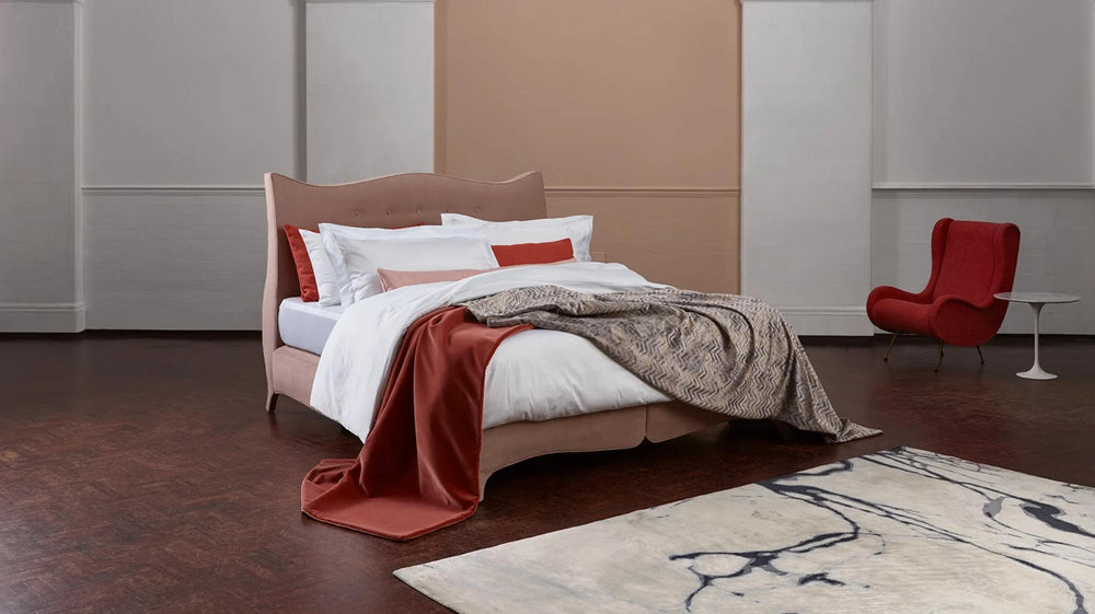 Savoir bed with a soft pink headboard