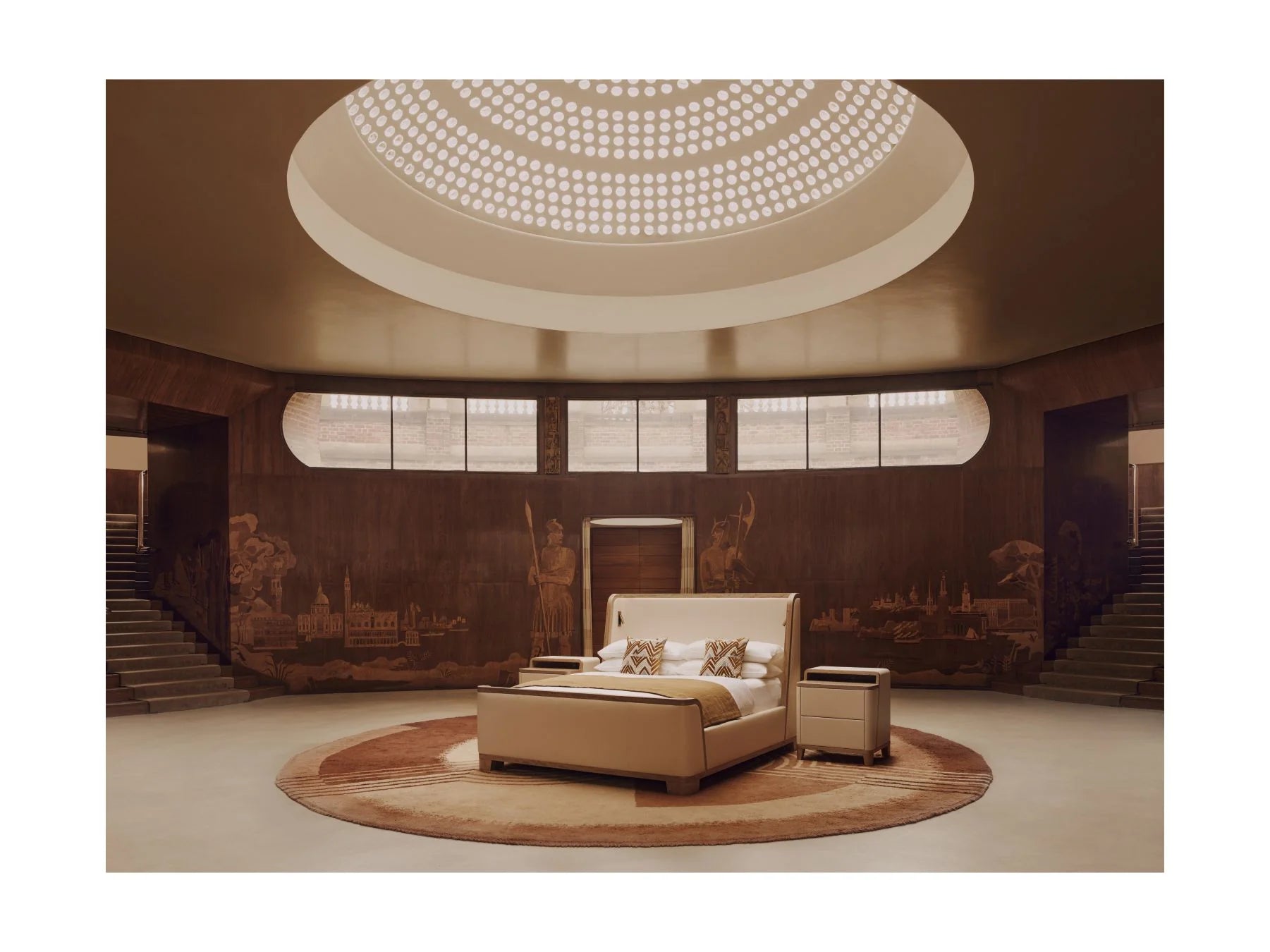 Luxurious room with a large bed and round ceiling light fixture.