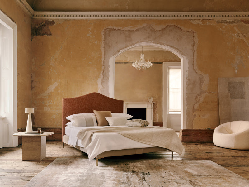 The Alex bed in a luxurious bedroom with ornate walls, and a chandelier.