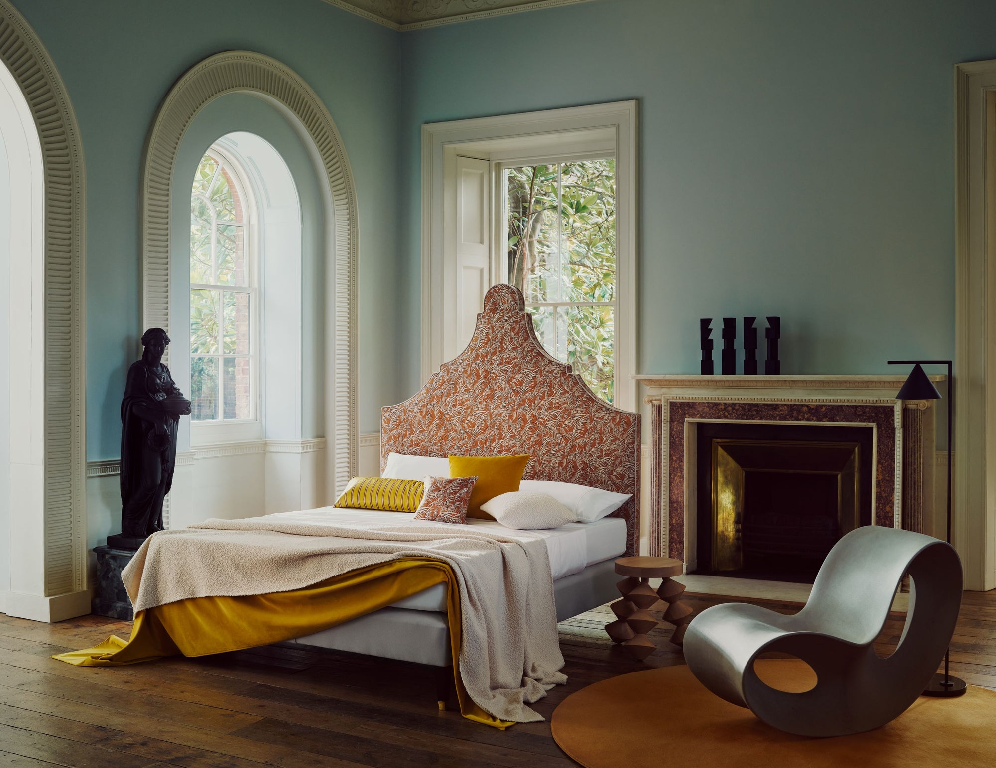 Luxurious bedroom with the Savoir Claudia bed, fireplace, and decorative elements.