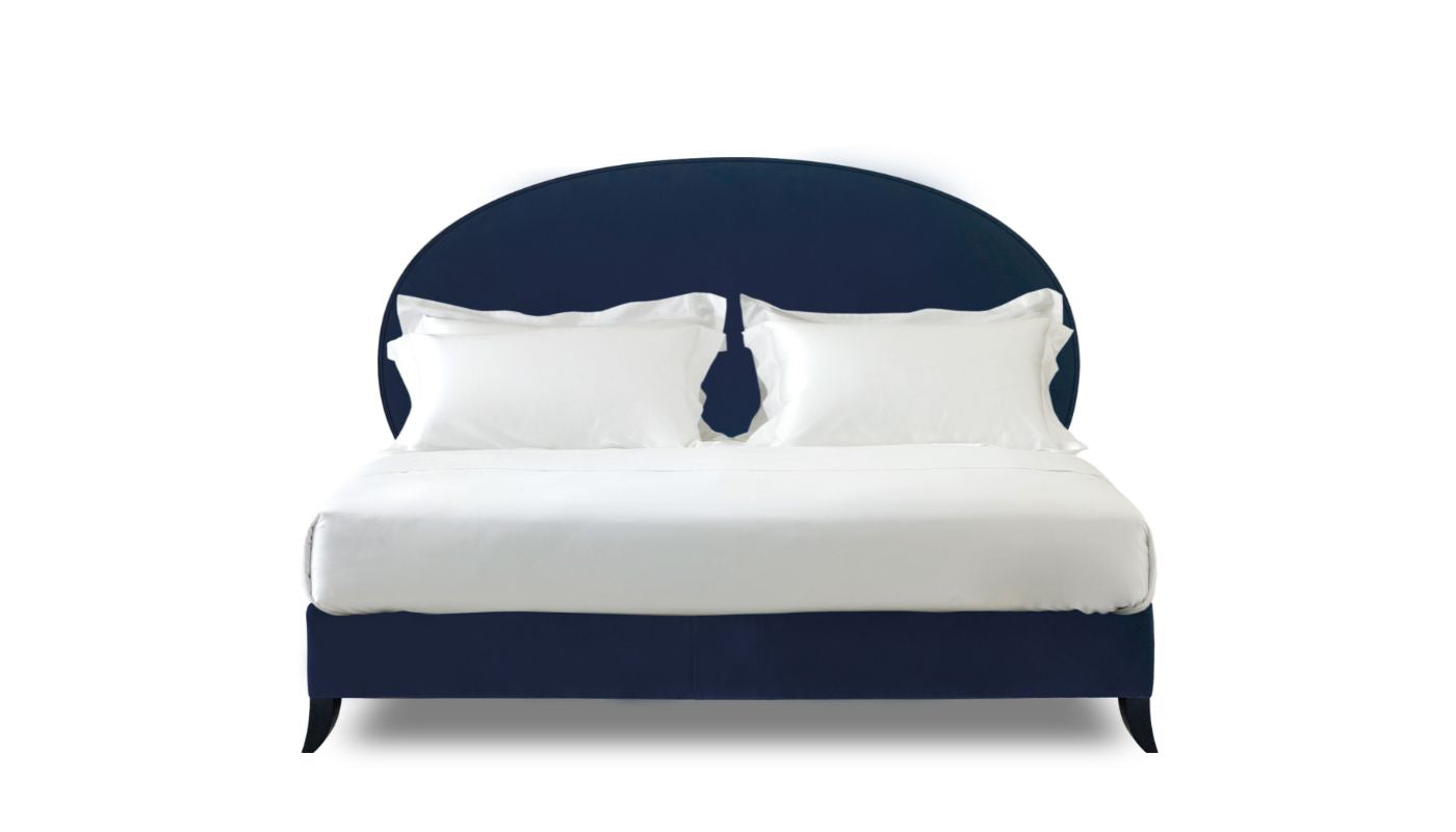 Undressed Elly bed with a navy blue fabric on headboard and base, featuring cushions