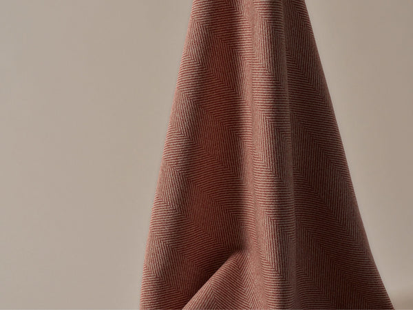 A close up of a small herringbone patterned fabric
