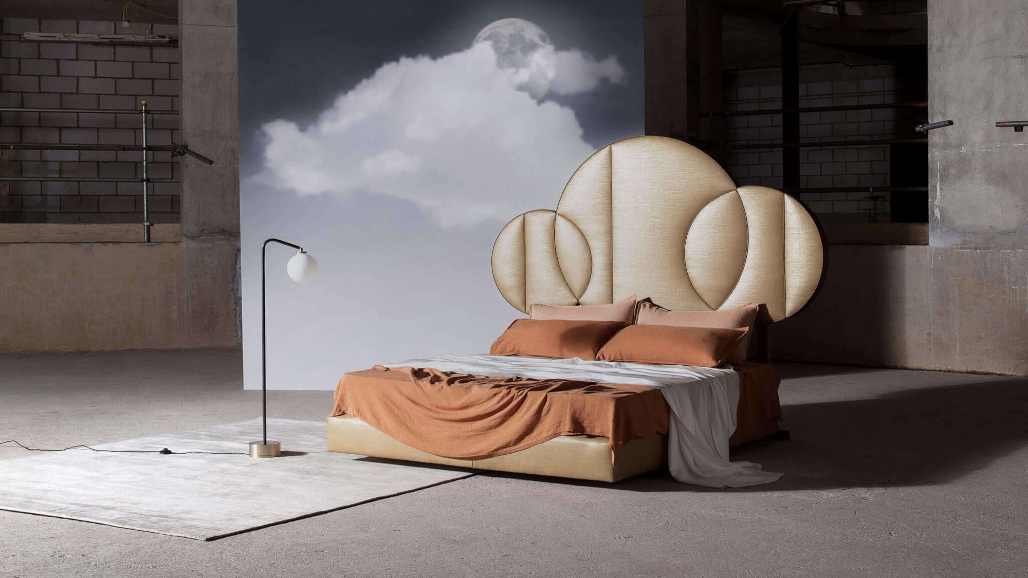 Moon bed photographed in side view and fully dressed in an industrial room