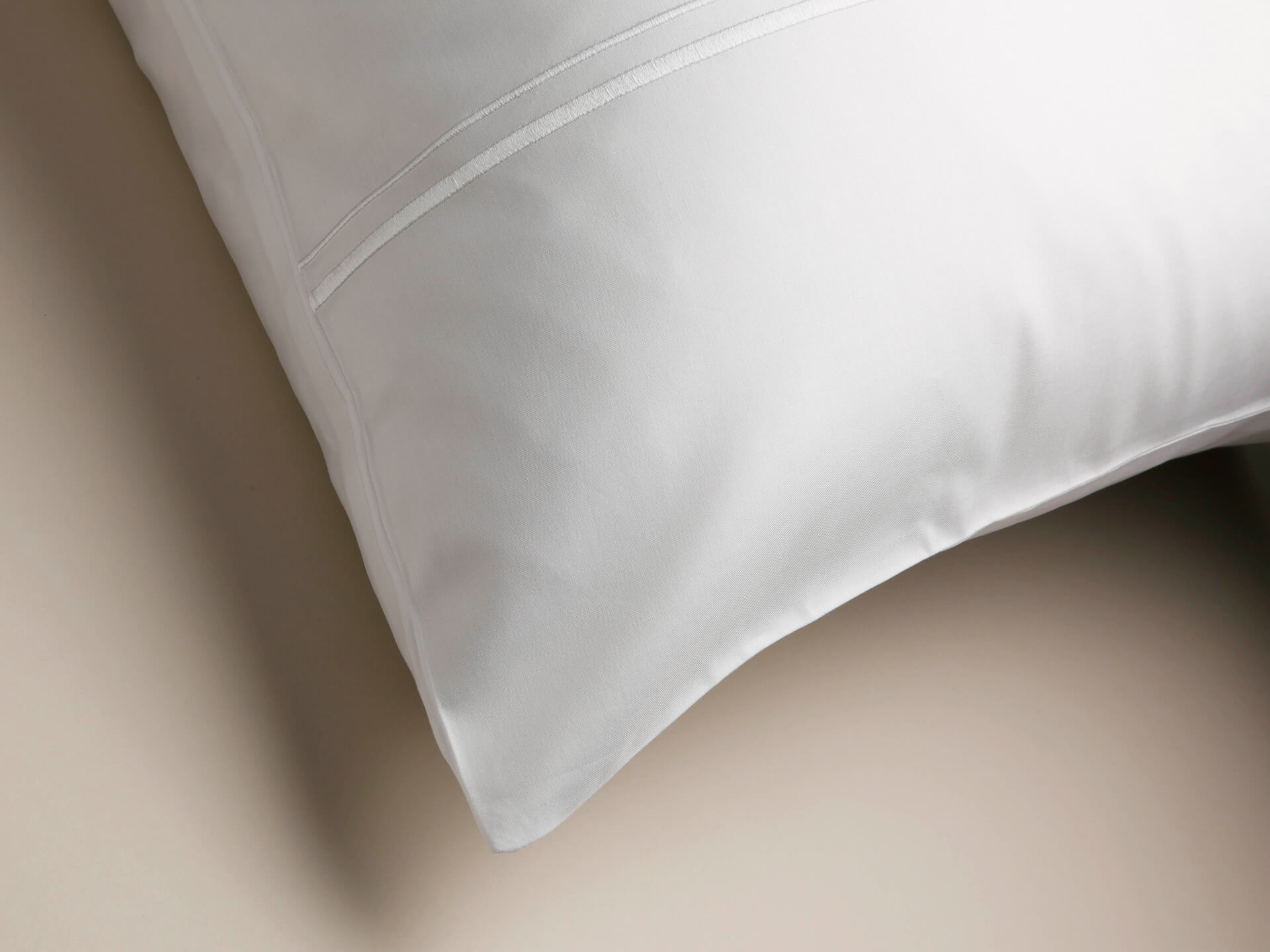 Corner view of a Cambridge pillowcase with corded white details