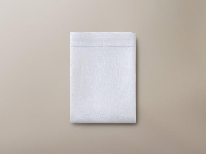 Top view of a folded Savoir organic linen flat sheet