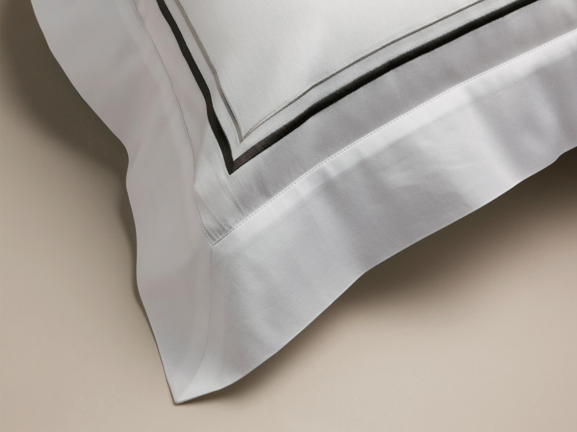 Corner view of grey corded detail on pillowcase