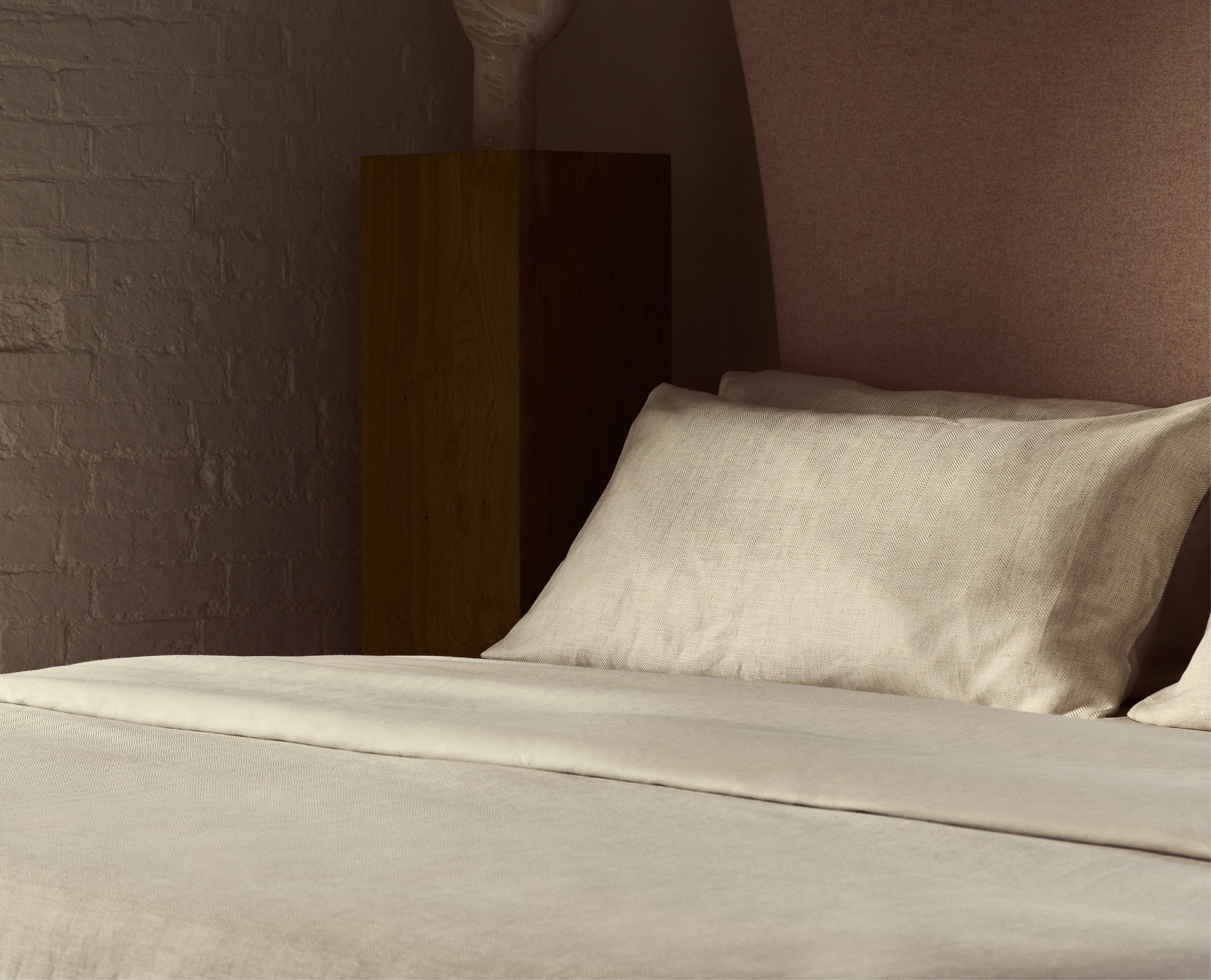 Herringbone Duvet Cover and Pillowcases in Oatmeal on a Savoir Bed