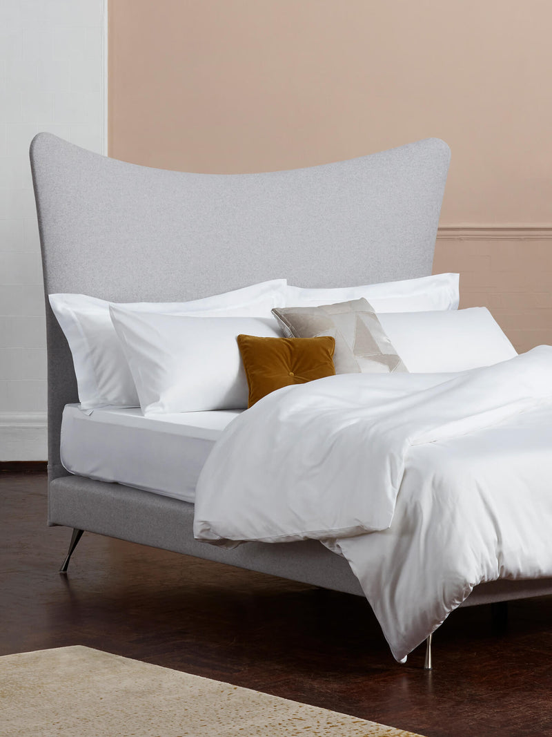 The Dream 300 white bed linen set photographed with the grey Amelia headboard